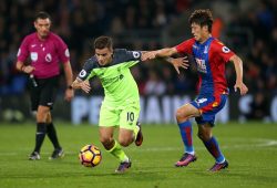 Philippe Coutinho of Liverpool gets away from Lee Chung-Yong of Crystal Palace (R)