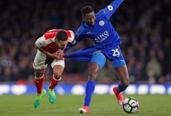 Theo Walcott of Arsenal and Wilfred Ndidi of Leicester City battle for a pair of blue shorts