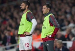 Mesut Ozil of Arsenal right and  Olivier Giroud of Arsenal wait to come off the bench