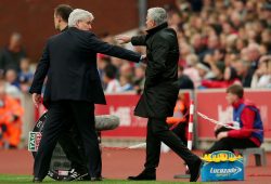 Stoke City manager Mark Hughes ushers Manchester United manager Jose Mourinho back into his technical area