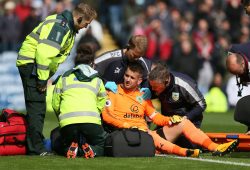 Burnley goal keeper Tom Heaton receives medical treatment after injuring himself