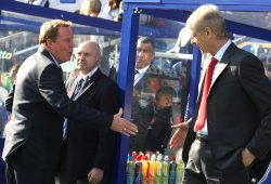 Rangers manager Harry Redknapp offers his hand to Arsene Wenger before the match.