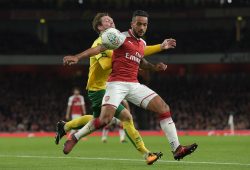 James Husband of Norwich City and Theo Walcott of Arsenal