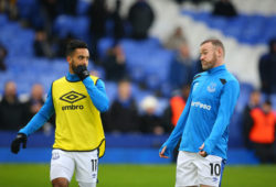 Theo Walcott speaks with Wayne Rooney during the pre-match warm-up prior to kick-off