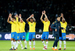 Brazil players applaud the crowd.