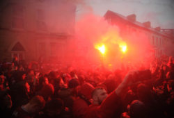 Liverpool fans let off flares and climb on police vehicles before their Champions League match against Roma, Liverpool, United Kingdom