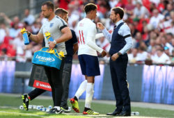 Dele Alli of England speaks with England Manager Gareth Southgate as he is substituted.