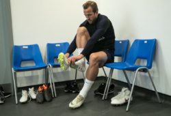 Harry Kane puts his boots on before the England Football Team Training Session