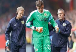 Burnley goalkeeper Nick Pope leaves the pitch injured after a challenge with Lewis Ferguson of Aberdeen