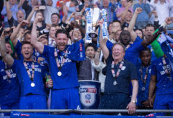 Sean Morrison of Cardiff City and Cardiff City manager Neil Warnock celebrate with the team after winning promotion to the Premier League