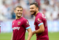 Jack Wilshere of West Ham smiles and laughs with Robert Snodgrass of West Ham as he takes to the field