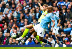 Laurent Depoitre of Huddersfield Town takes on Vincent Kompany of Manchester City