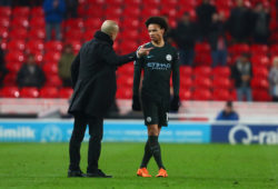 Pep Guardiola, manager of Manchester City gives Leroy Sane a post-match debrief