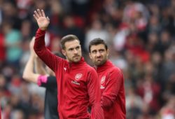Aaron Ramsey of Arsenal waves to his family as Sokratis Papastathopoulos  looks on