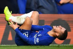 Eden Hazard of Chelsea holds his left ankle as he goes down injured