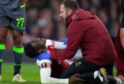 The Arsenal medic tends to Danny Welbeck of Arsenal after he goes down with a suspected serious leg injury