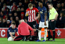 Luke Shaw of Manchester United is seen with medics after picking up an injury.