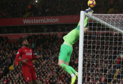 Everton goalkeeper Jordan Pickford fails to get the ball under control as Divock Origi of Liverpool waits to score the opening goal