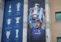 The FA cup holders, an image of Chelsea captain Gary Cahill lifting the trophy outside Stamford Bridge