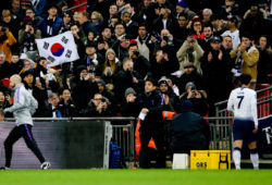 Son Heung-Min of Tottenham Hotspur  receives partisan support from the South Korean members of the crowd (Left) with the Taegukgi flag as he leaves the field when replaced.