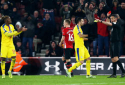 Referee Andre Marriner shows Wilfried Zaha of Crystal Palace a red card for a second yellow card offence.