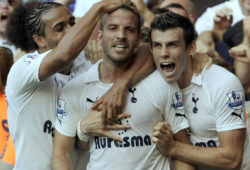 Tottenham Hotspur's Rafael van der Vaart, centre, celebrates with Gareth Bale, right, and Younes Kaboul after he scores the opening goal against Arsenal during their English Premier League soccer match at White Hart Lane stadium, London, Sunday, Oct. 2, 2011. (AP Photo/Tom Hevezi)