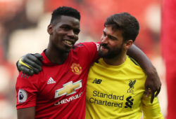 Soccer Football - Premier League - Manchester United v Liverpool - Old Trafford, Manchester, Britain - February 24, 2019 Manchester United's Paul Pogba with Liverpool's Alisson at the end of the match Action Images via Reuters/Lee Smith EDITORIAL USE ONLY. No use with unauthorized audio, video, data, fixture lists, club/league logos or "live" services. Online in-match use limited to 75 images, no video emulation. No use in betting, games or single club/league/player publications. Please contact your account representative for further details.