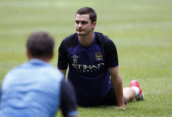 Manchester City's Adam Johnson stretches during a training session ahead of Monday's friendly soccer match against Malaysia XI, a Malaysia League selection, as part of the football club team's Asia tour in Kuala Lumpur, Malaysia, Sunday, July 29, 2012. (AP Photo/Lai Seng Sin)