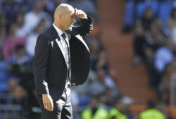 Real Madrid's coach Zinedine Zidane covers his eyes from the sun during a Spanish La Liga soccer match between Real Madrid and Celta at the Santiago Bernabeu stadium in Madrid, Spain, Saturday, March 16, 2019.(AP Photo/Paul White)
