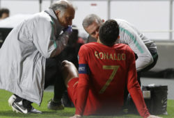 Portugal's Cristiano Ronaldo receives treatment from medical staff during the Euro 2020 group B qualifying soccer match between Portugal and Serbia at the Luz stadium in Lisbon, Portugal, Monday, March 25, 2019. (AP Photo/Armando Franca)