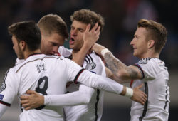 Germany's Thomas Mueller, center, celebrates with, from left, Mesut Ozil, Matthias Ginter and Marco Reus after scoring the opening goal  during the Euro 2016 group D qualifying soccer match between Germany and Georgia in Leipzig, Germany, Sunday, Oct. 11, 2015. (AP Photo/Michael Sohn)