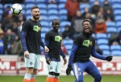 Chelsea's Callum Hudson-Odoi, right, warms up with teammates wearing an anti racist campaign 'Kick It Out' T-shirt prior to their English Premier League soccer match against Cardiff, at the Cardiff City Stadium in Cardiff, Wales, Sunday March 31, 2019. (Nick Potts/PA via AP)