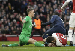 Arsenal's goalkeeper Bernd Leno, left, Arsenal's Laurent Koscielny, bottom, and Manchester United's Romelu Lukaku challenge for the ball during the English Premier League soccer match between Arsenal and Manchester United at the Emirates Stadium in London, Sunday, March 10, 2019. (AP Photo/Tim Ireland)