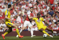 Arsenal's Sead Kolasinac, center, fights for the ball with Crystal Palace's Aaron Wan-Bissaka during the English Premier League soccer match between Arsenal and Crystal Palace at the Emirates Stadium in London, Sunday, April 21, 2019. (AP Photo/Tim Ireland)