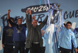 Manchester City coach Pep Guardiola, left, and his assistant Mikel Arteta hold the trophy as they celebrate with their supporters at the Etihad Stadium in Manchester, England, Sunday May 12, 2019 the day they won the English Premier League title. Manchester City retained the Premier League trophy after coming from behind to beat Brighton 4-1 and see off Liverpool's relentless challenge on the final day of the season on Sunday. (AP Photo/Jon Super)