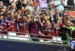 Aston Villa's Jack Grealish, centre left, and James Chester, centre right, celebrate with the trophy after winning the English Championship Play-off soccer final between Aston Villa and Derby County at Wembley Stadium, London, Monday, May 27, 2019. (Scott Wilson/PA via AP)