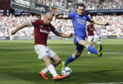 West Ham's Pablo Zabaleta, left, shoots at goal as Leicester City's Ben Chilwell attempts to block during the English Premier League soccer match between West Ham and Leicester City at the London stadium in London, Saturday, April 20, 2019. (AP Photo/Kirsty Wigglesworth)