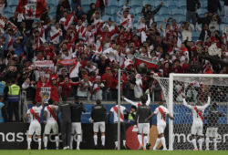 Peru's players celebrates with fans defeating Chile at a Copa America semifinal soccer match at the Arena do Gremio in Porto Alegre, Brazil, Wednesday, July 3, 2019. (AP Photo/Silvia Izquierdo)