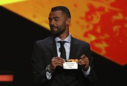 Former Chelsea defender Ashley Cole shows the name of Manchester United during the UEFA Europa League group stage draw at the Grimaldi Forum, in Monaco, Friday, Aug. 30, 2019. (AP Photo/Daniel Cole)  XTS104