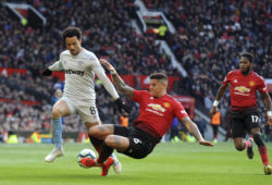 Manchester United's Marcos Rojo fights for the ball with West Ham's Felipe Anderson, left, during the English Premier League soccer match between Manchester United and West Ham United at Old Trafford in Manchester, England, Saturday, April 13, 2019. (AP Photo/Rui Vieira)