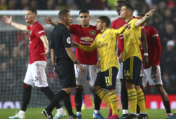 Arsenal's Lucas Torreira, centre, Arsenal's Granit Xhaka, right, argues with referee Kevin Friend during the English Premier League soccer match between Manchester United and Arsenal at Old Trafford in Manchester, England, Monday, Sept. 30, 2019. (AP Photo/Dave Thompson)  XSG111