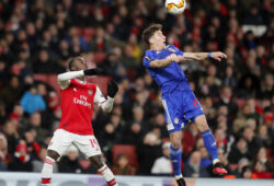 Arsenal's Nicolas Pepe, left, and Olympiakos' Kostas Tsimikas challenge for the ball during the Europa League round of 32, second leg, soccer match between Arsenal and Olympiakos at Emirates stadium in London, England, Thursday, Feb. 27, 2020 . (AP Photo/Frank Augstein)  FAS119