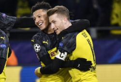 Dortmund's Jadon Sancho, left, is embraced by Dortmund's Marco Reus after scoring the opening goal during the Champions League Group F soccer match between Borussia Dortmund and Slavia Praha in Dortmund, Germany, Tuesday, Dec. 10, 2019. (AP Photo/Martin Meissner)  mme109