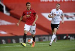 Manchester United's Nemanja Matic, left, passes the ball during the English Premier League soccer match between Manchester United and Sheffield United at Old Trafford in Manchester, England, Wednesday, June 24, 2020. (Michael Regan/Pool via AP) XTS144