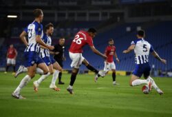 Manchester United's Mason Greenwood, center, scores the opening goal of his team during the English Premier League soccer match between Brighton & Hove Albion and Manchester United at the AMEX Stadium in Brighton, England, Tuesday, June 30, 2020. (Andy Rain/Pool via AP)  XTS116