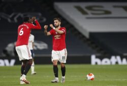 Manchester United's Bruno Fernandes, right, celebrates with Paul Pogba after scoring his side's first goal during the English Premier League soccer match between Tottenham Hotspur and Manchester United at Tottenham Hotspur Stadium in London, England, Friday, June 19, 2020. (AP Photo/Matt Childs, Pool)  TH141