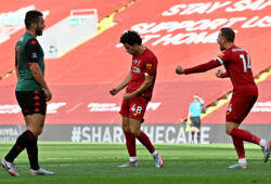Liverpool's Curtis Jones, center, celebrates after scoring his side's second goal during the English Premier League soccer match between Liverpool and Aston Villa at Anfield Stadium in Liverpool, England, Sunday, July 5, 2020. (Paul Ellis/Pool via AP)  XAF159