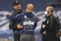 Liverpool's manager Jurgen Klopp, left, and Manchester City's head coach Pep Guardiola embrace after the English Premier League soccer match between Manchester City and Liverpool at Etihad Stadium in Manchester, England, Thursday, July 2, 2020. (AP Photo/Laurence Griffiths,Pool)  XMB192