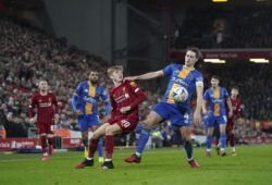 Shrewsbury Town's David Edwards, right, fights for the ball with Liverpool's Jake Cain during the English FA Cup Fourth Round replay soccer match between Liverpool and Shrewsbury Town at Anfield Stadium, Liverpool, England, Tuesday, Feb. 4, 2020. (AP Photo/Jon Super)  HAS147