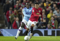 Manchester United's Jesse Lingard, right vies for the ball with Manchester City's Benjamin Mendy during the English League Cup semifinal first leg soccer match between Manchester United and Manchester City and at Old Trafford, Manchester, England, Tuesday, Jan. 7, 2020. (AP Photo/Jon Super)  XAG117